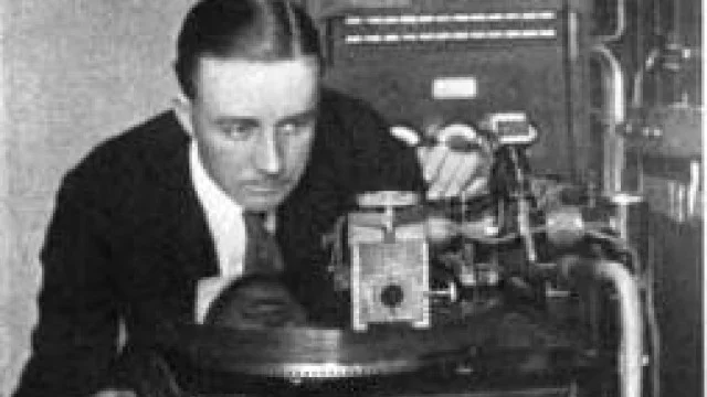 A technician working at an early disc-recording machine